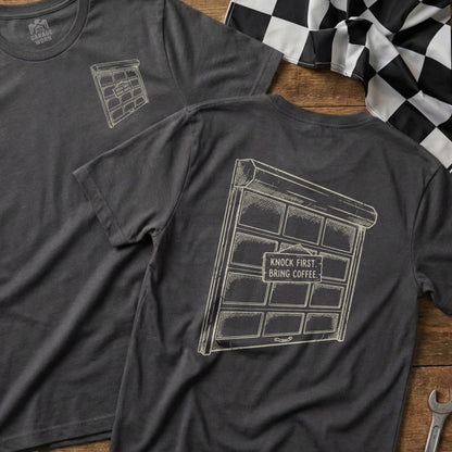 Dark grey t-shirt with a sketch of a garage door and text.