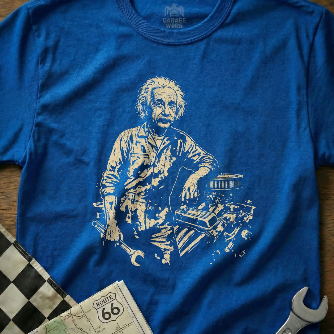 Albert Einstein leaning on car engine holding a wrench on blue t-shirt.