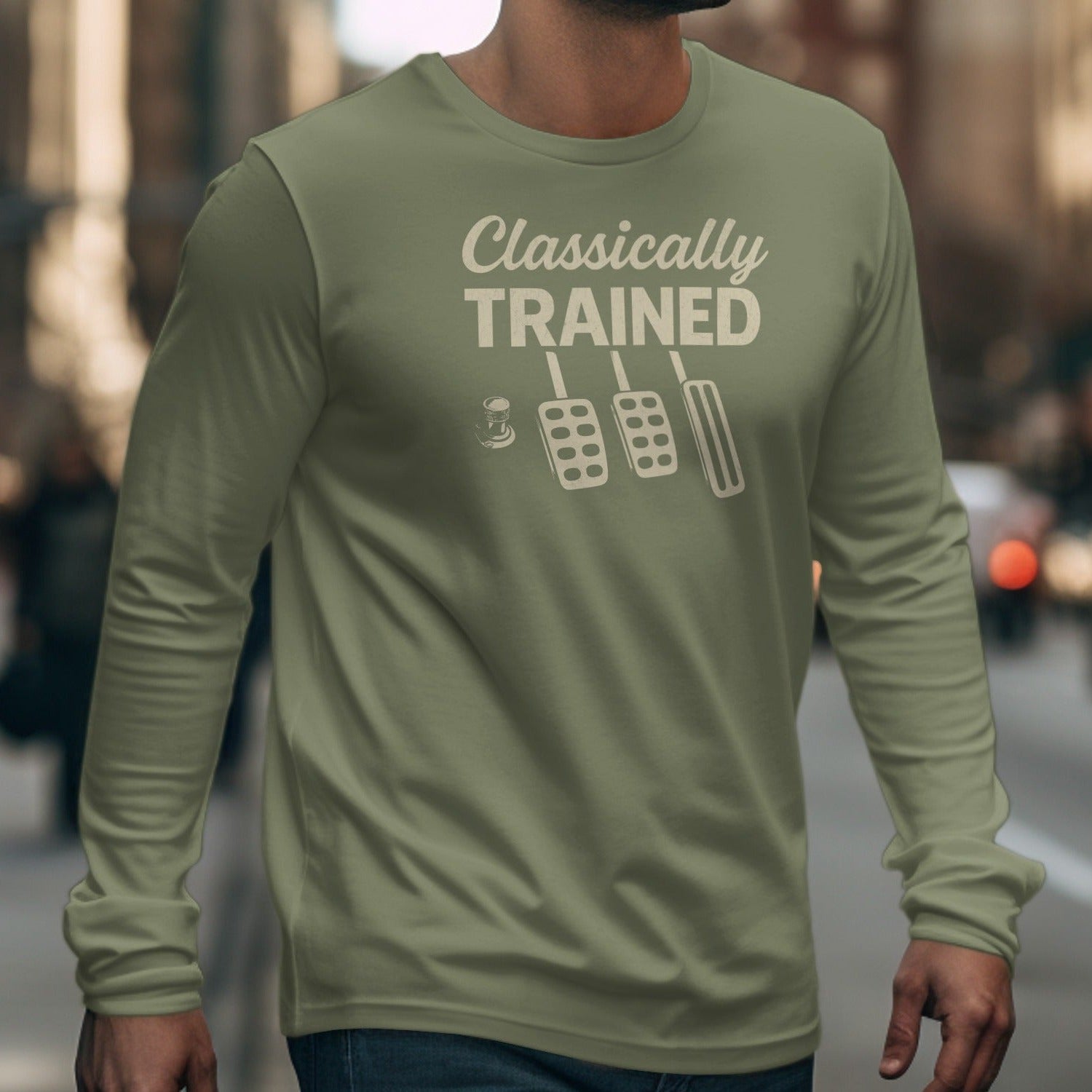 Olive long sleeve shirt with "Classically TRAINED" and clutch, brake, accelerator pedals graphic.