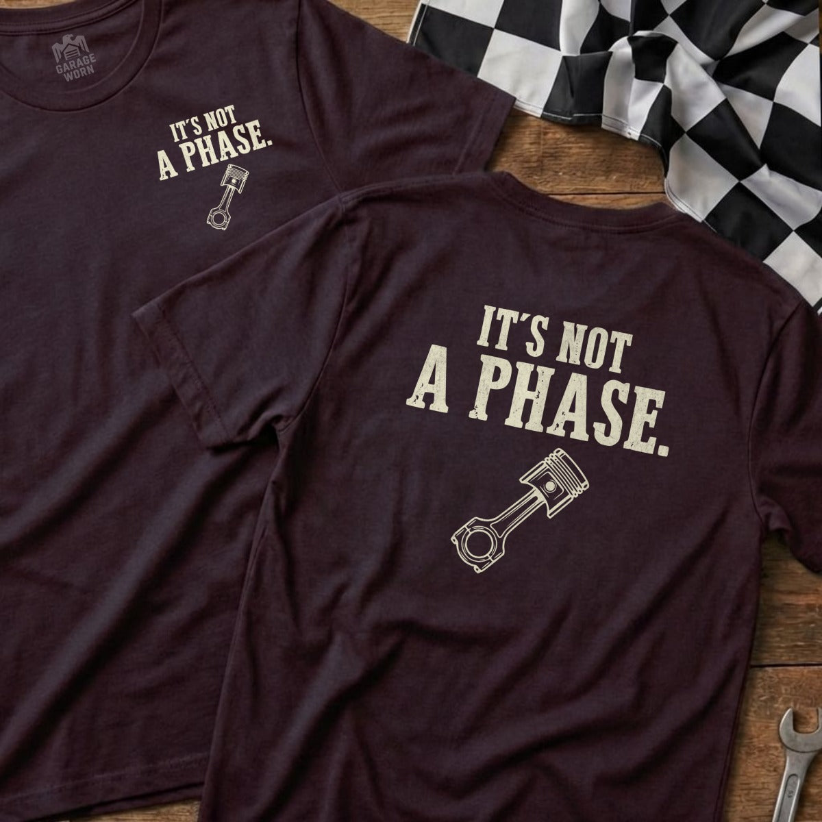 Maroon t-shirt with "It's not a phase." and a piston graphic.