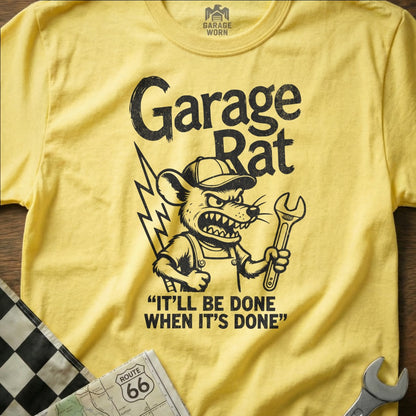 Yellow t-shirt with cartoon rat wrench and text "Garage Rat It'll Be Done When It's Done".