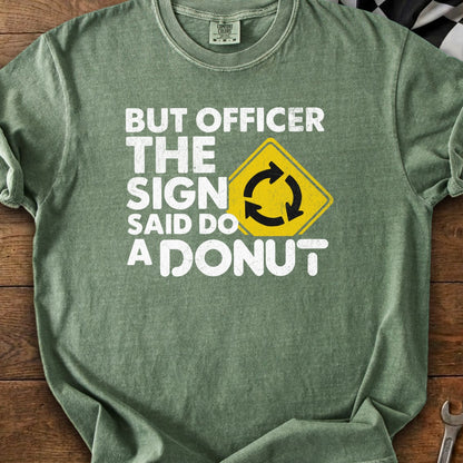 Green t-shirt with white text: "BUT OFFICER THE SIGN SAID DO A DONUT" and a yellow traffic sign.
