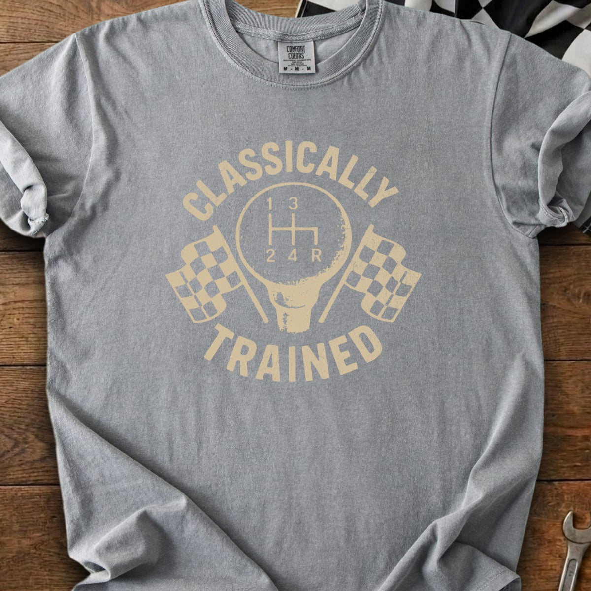 Grey t-shirt with graphic design of gear shift and checkered flags.