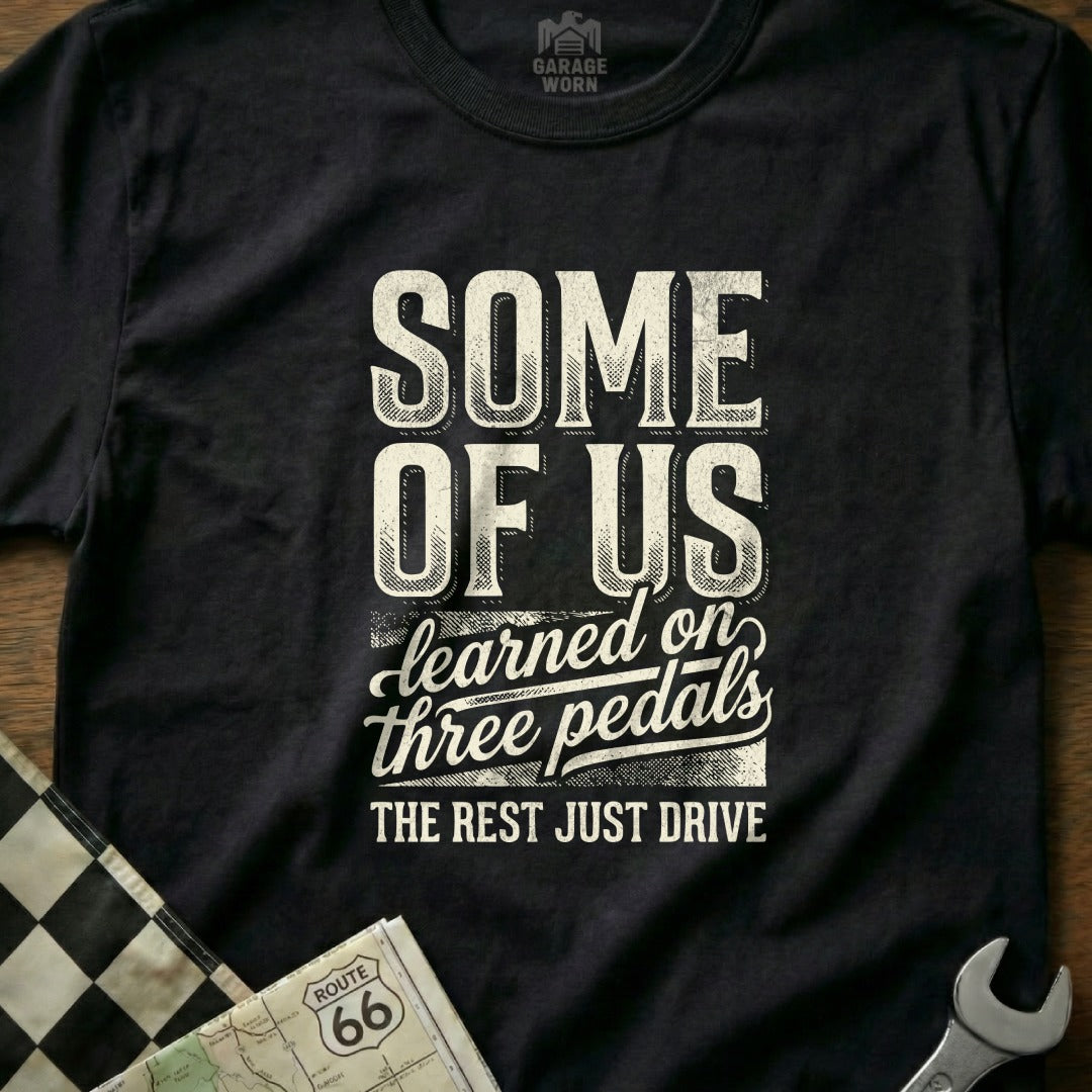 T-shirt with text "SOME OF US learned on three pedals THE REST JUST DRIVE".