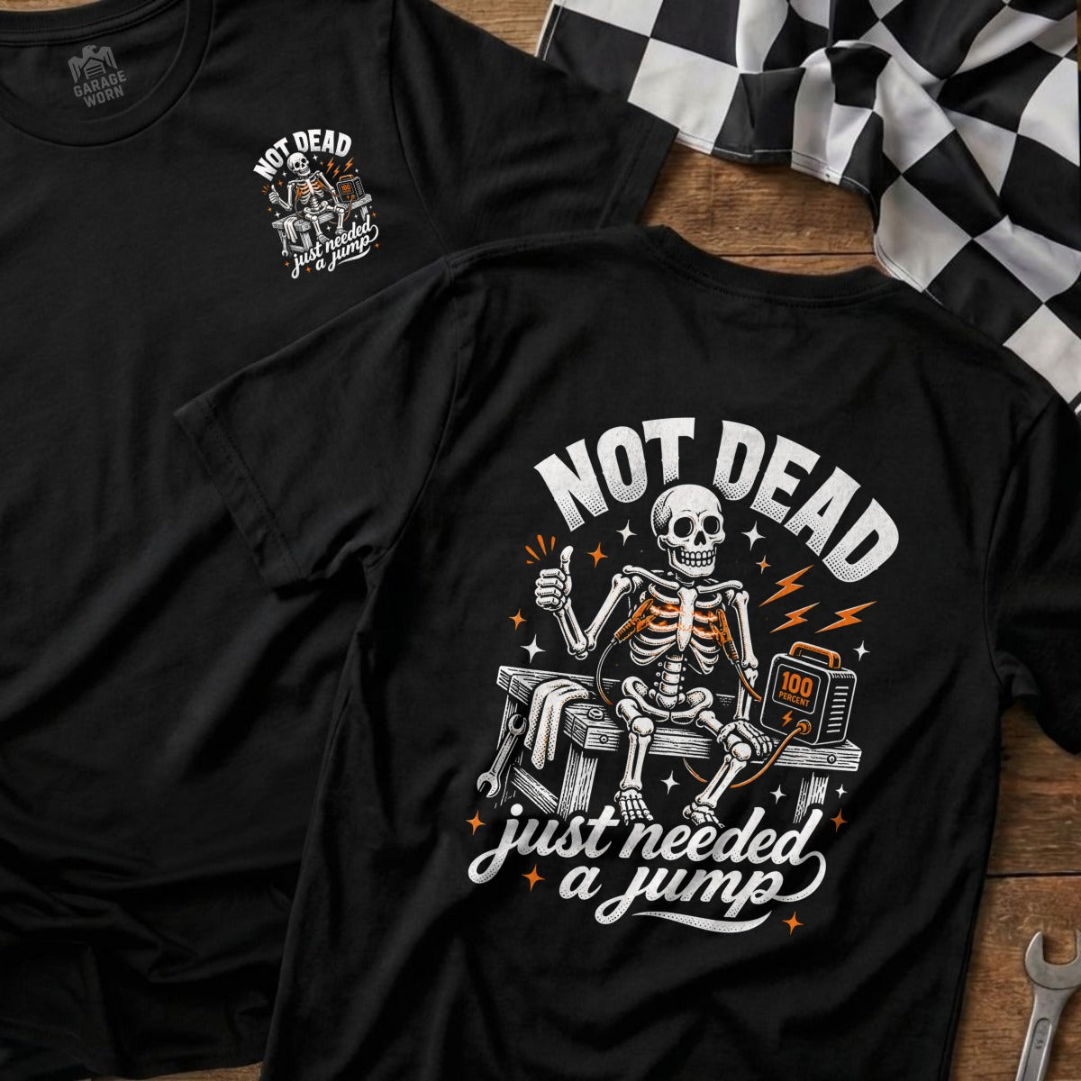 Black t-shirt with skeleton giving thumbs up and text "NOT DEAD just needed a jump."