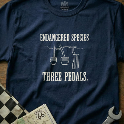Navy t-shirt with "ENDANGERED SPECIES THREE PEDALS" text and pedal illustration.
