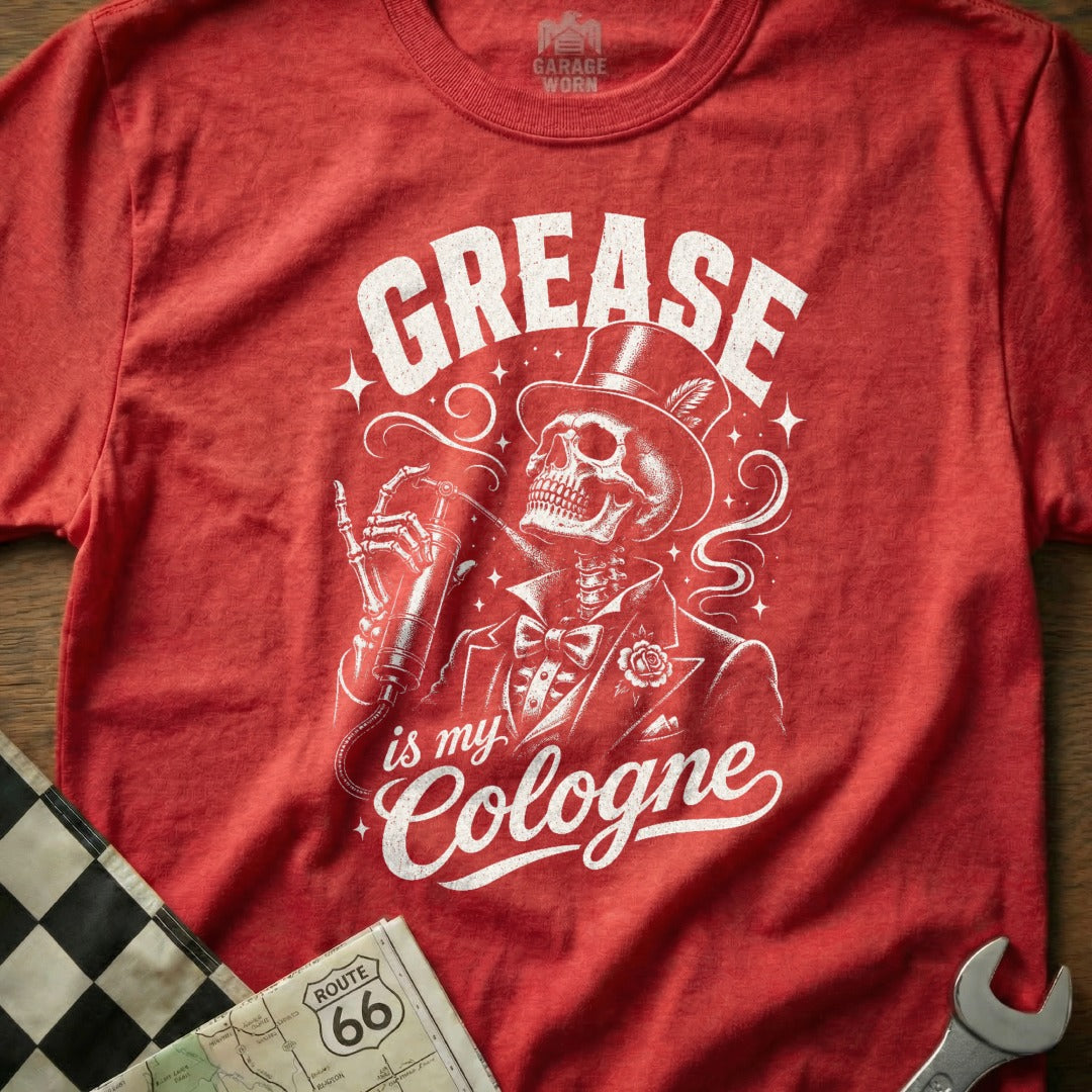 Red t-shirt with skeleton in top hat spraying cologne, "GREASE is my Cologne" text.