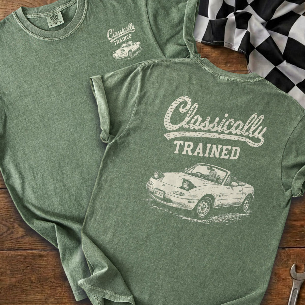 Green t-shirt with "Classically TRAINED" text and a drawing of a convertible car.
