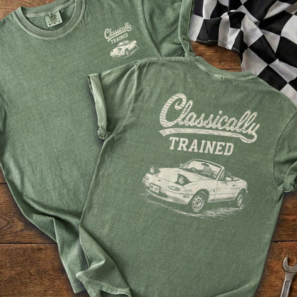 Green t-shirt with "Classically TRAINED" text and a drawing of a convertible car.