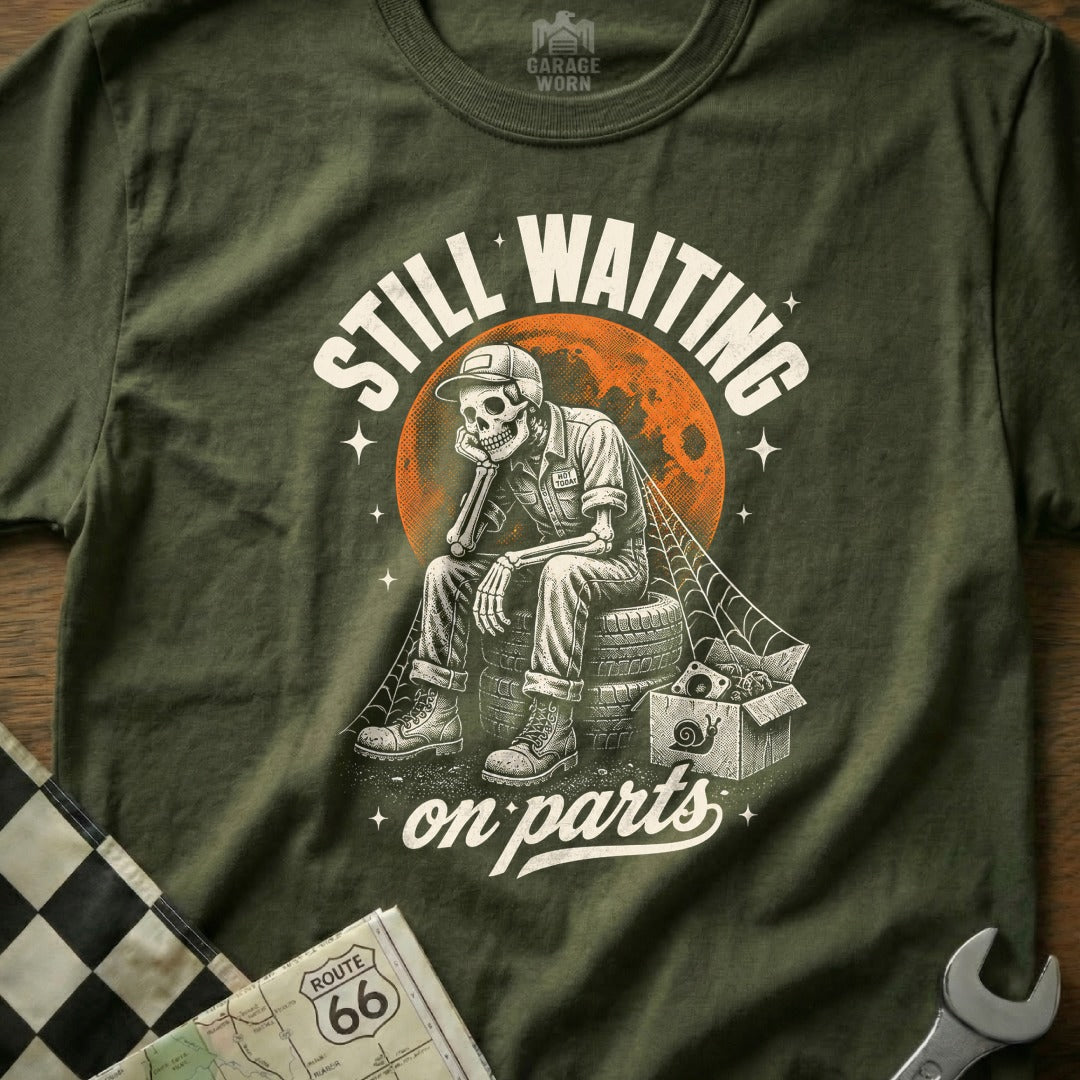 Skeleton mechanic sits on tires, text reads "Still Waiting on Parts".