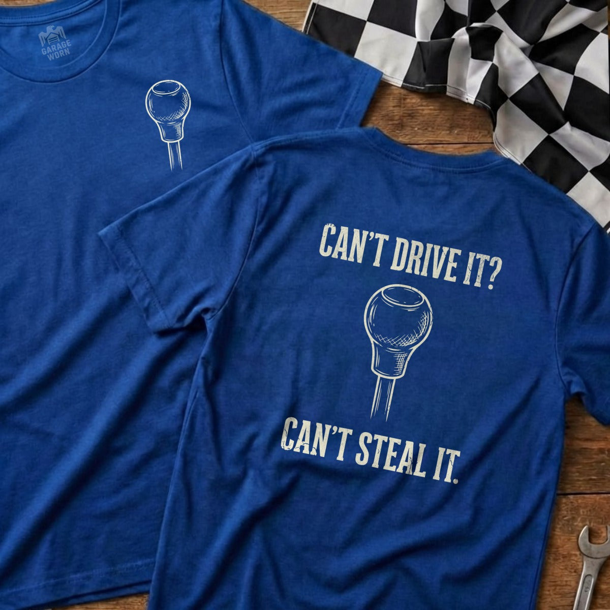 Two blue t-shirts with "Can't Drive It? Can't Steal It." text and gear shift graphic.
