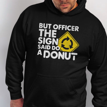 Black hoodie with white text and a yellow roundabout sign that reads "BUT OFFICER THE SIGN SAID DO A DONUT".