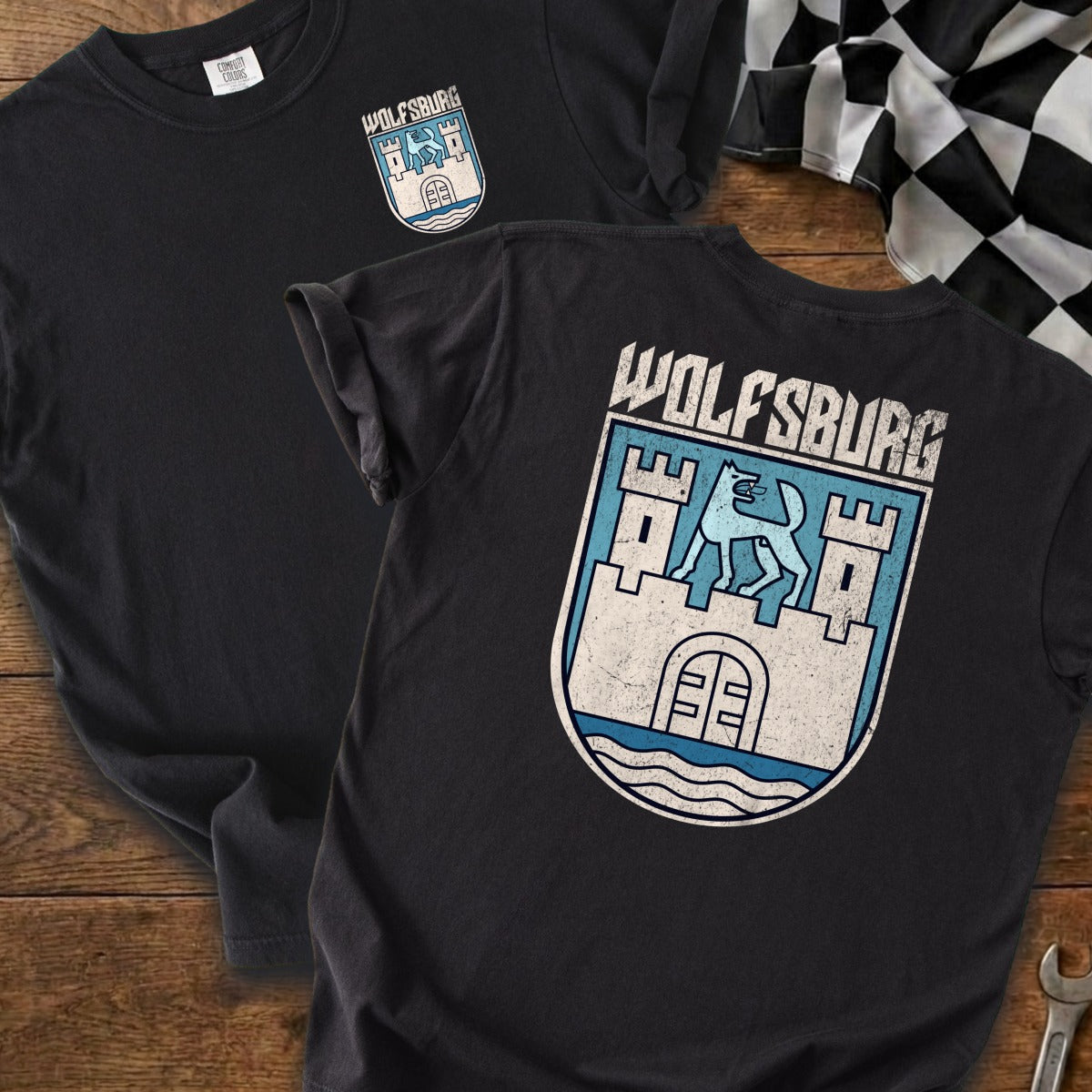 Black t-shirts with a Wolfsburg crest and text graphic.