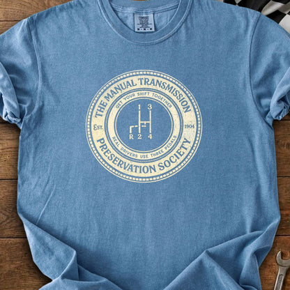 Blue t-shirt with "The Manual Transmission Preservation Society" and gear shift graphic.