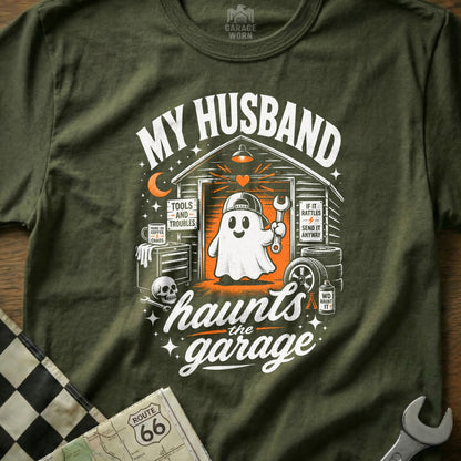 Green t-shirt graphic with ghost holding wrench: "My Husband Haunts the Garage".