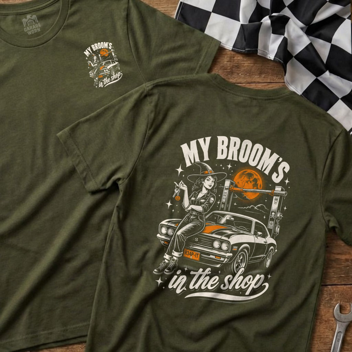 Green t-shirt with "My Broom's in the shop" graphic featuring a witch and a car.