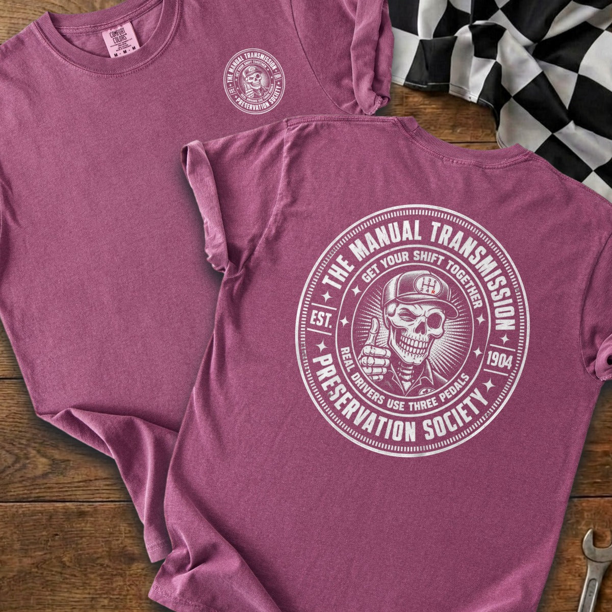 Maroon t-shirt with a circular graphic of a skeleton giving a thumbs up.