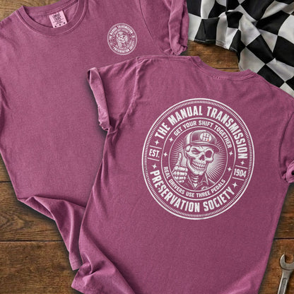 Maroon t-shirt with a circular graphic of a skeleton giving a thumbs up.