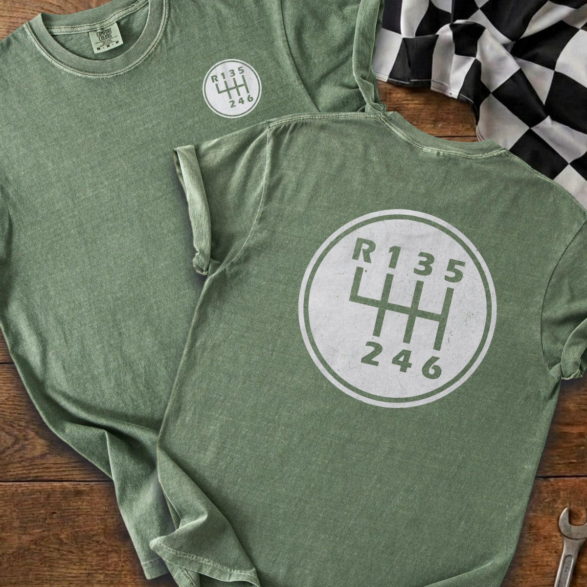 Green t-shirts with a white shift pattern graphic of R135 and 246.