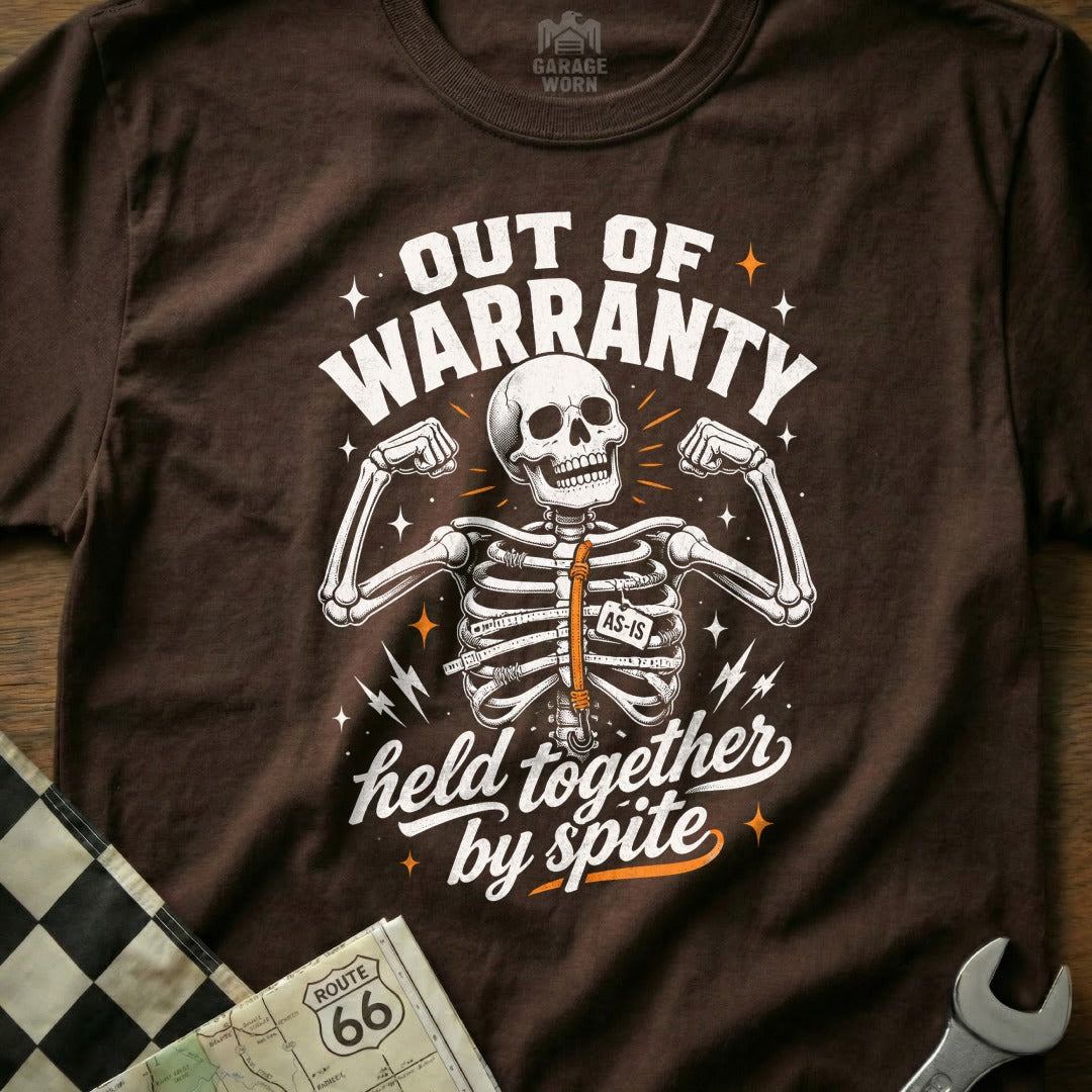 Brown t-shirt with skeleton graphic reading "Out of Warranty" and "Held Together by Spite".