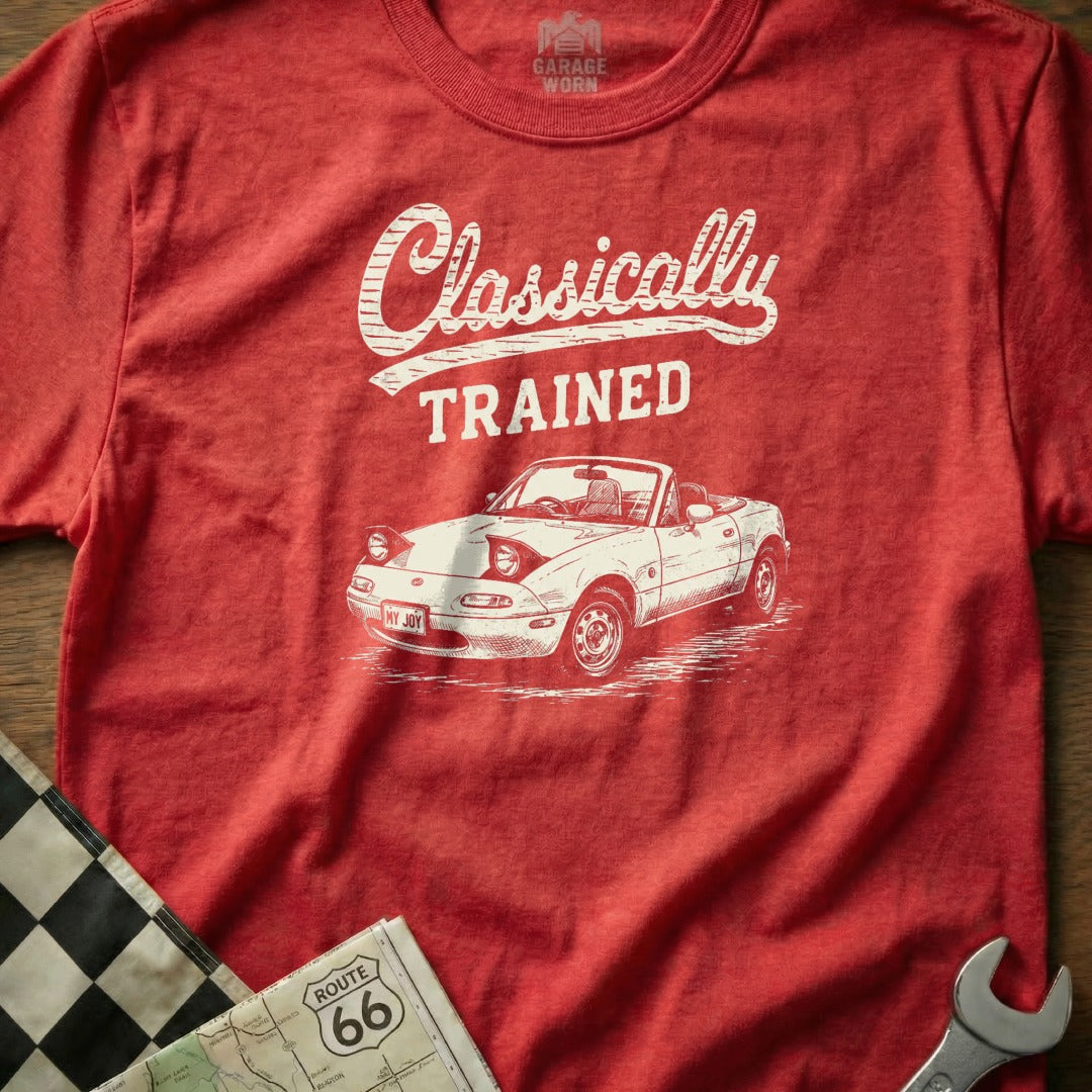 Red t-shirt with white graphic of a convertible car, "Classically TRAINED" text, and "MY JOY" license plate.