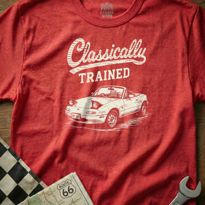 Red t-shirt with white graphic of a convertible car, "Classically TRAINED" text, and "MY JOY" license plate.