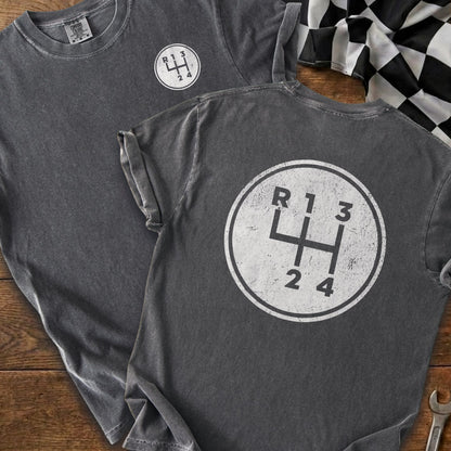 Grey t-shirt with white manual gear shift pattern graphic.