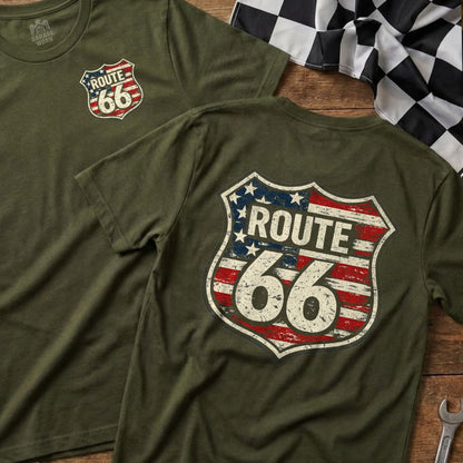 Green t-shirts with distressed Route 66 shield logo on wooden background.