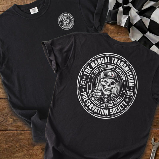 Black t-shirt with "The Manual Transmission Preservation Society" logo featuring a skeleton.