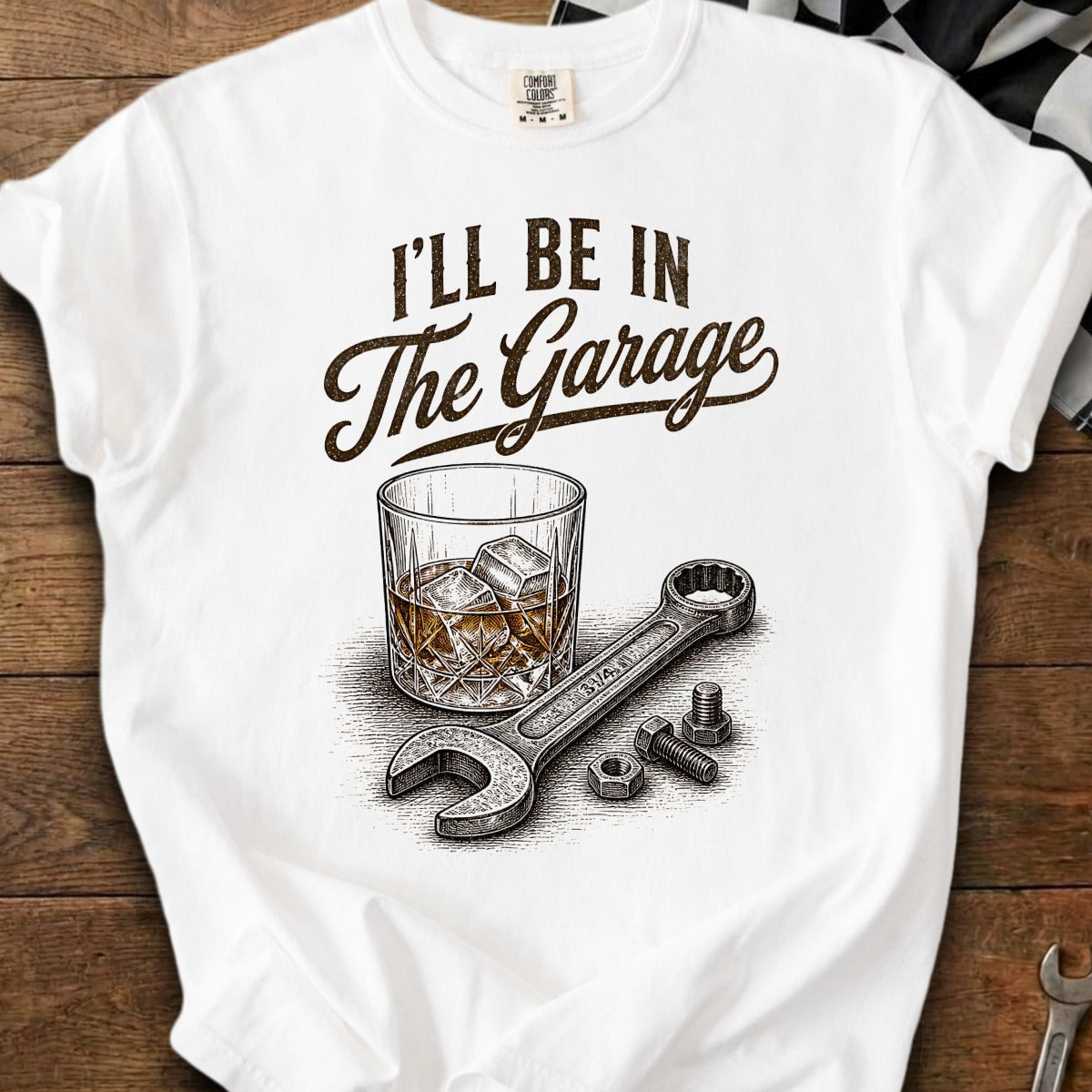 White t-shirt graphic: "I'll be in the Garage" with whiskey glass, wrench, and bolts.