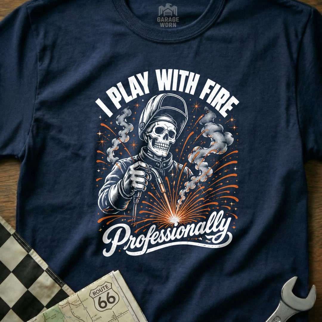 Navy t-shirt graphic of a skeleton welder with text "I PLAY WITH FIRE Professionally".