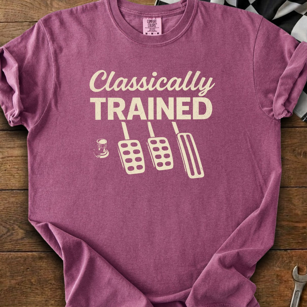 T-shirt with cream text "Classically TRAINED" and pedal graphic.