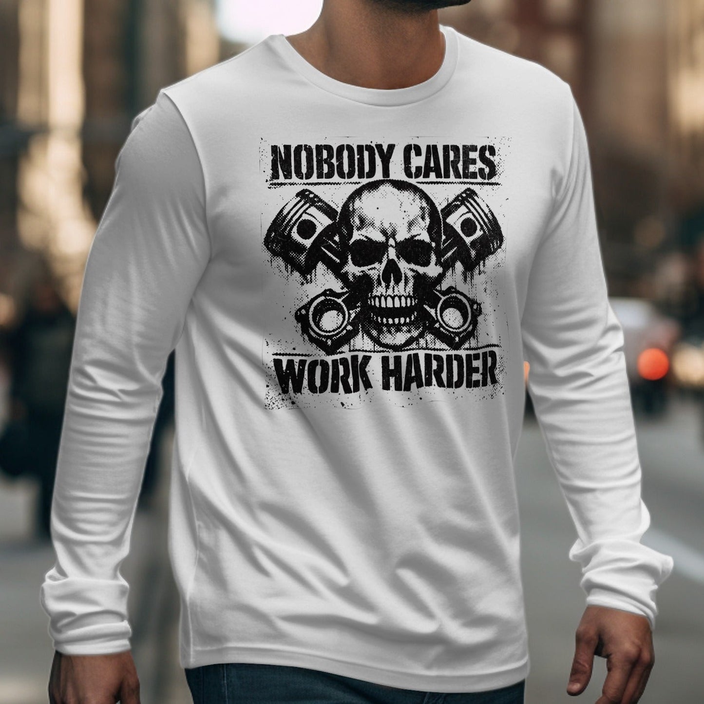 White long-sleeve shirt with skull, pistons, and "Nobody Cares Work Harder" text.