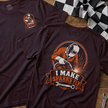 T-shirt graphic of a welder in orange, with the text "I MAKE SPARKS FLY".