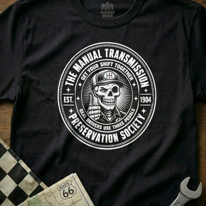 Black t-shirt with "The Manual Transmission Preservation Society" circular logo.