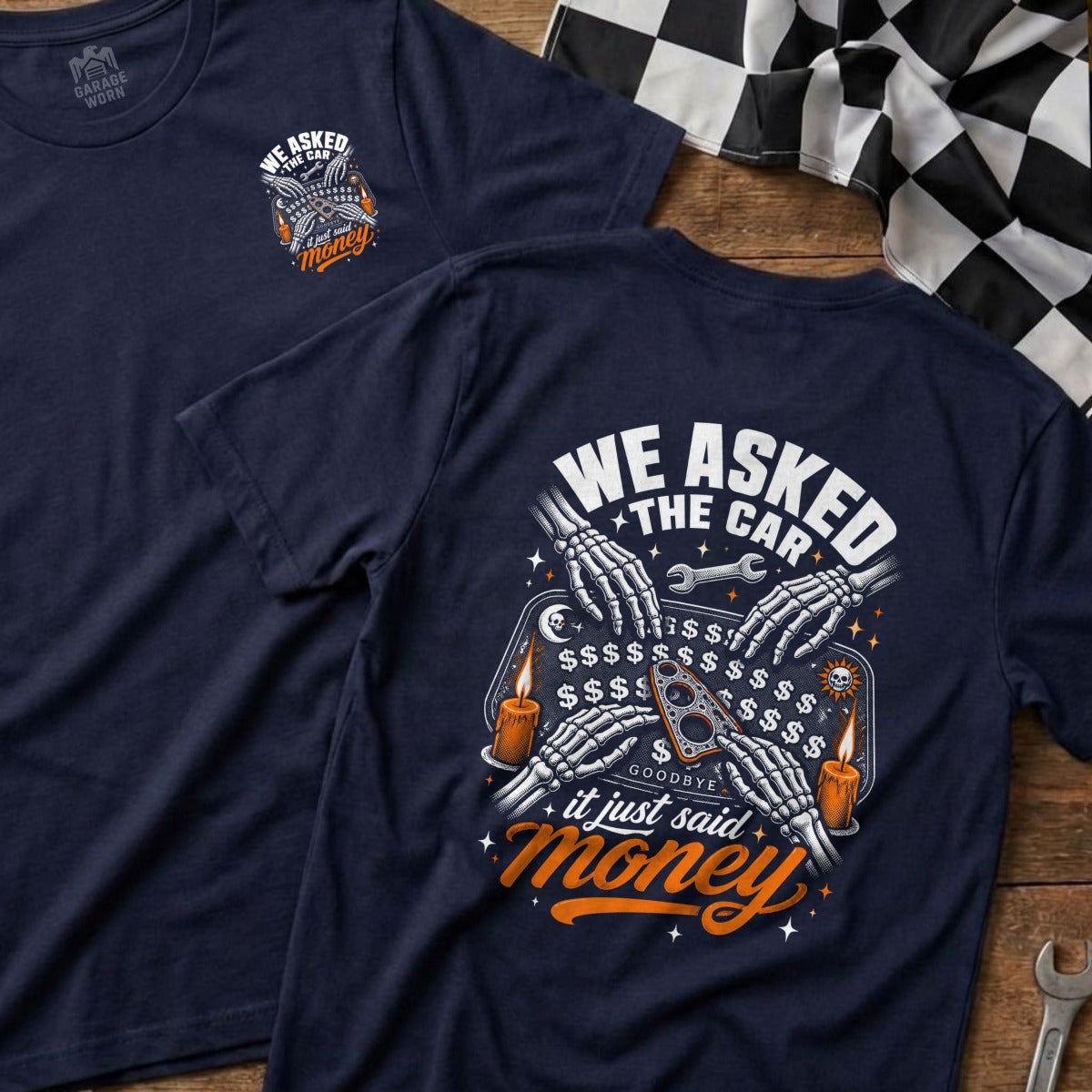 Navy t-shirt with "We Asked the Car, It Just Said Money" Ouija board graphic.