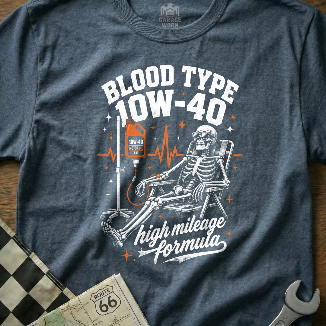 Skeleton receiving IV drip of 10W-40 motor oil, "Blood Type 10W-40 high mileage formula" text.