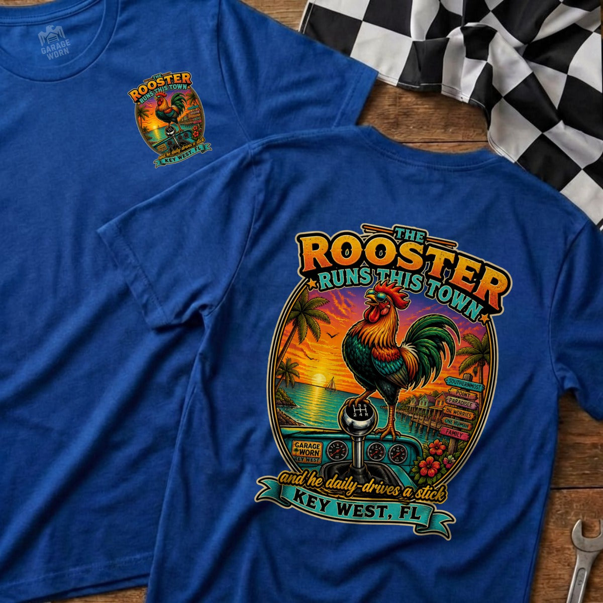 Blue t-shirt featuring a rooster in sunglasses on a stick shift, with "The Rooster Runs This Town Key West, FL".
