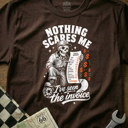 Skeleton mechanic reads long invoice with humor. "Nothing scares me, I've seen the invoice."