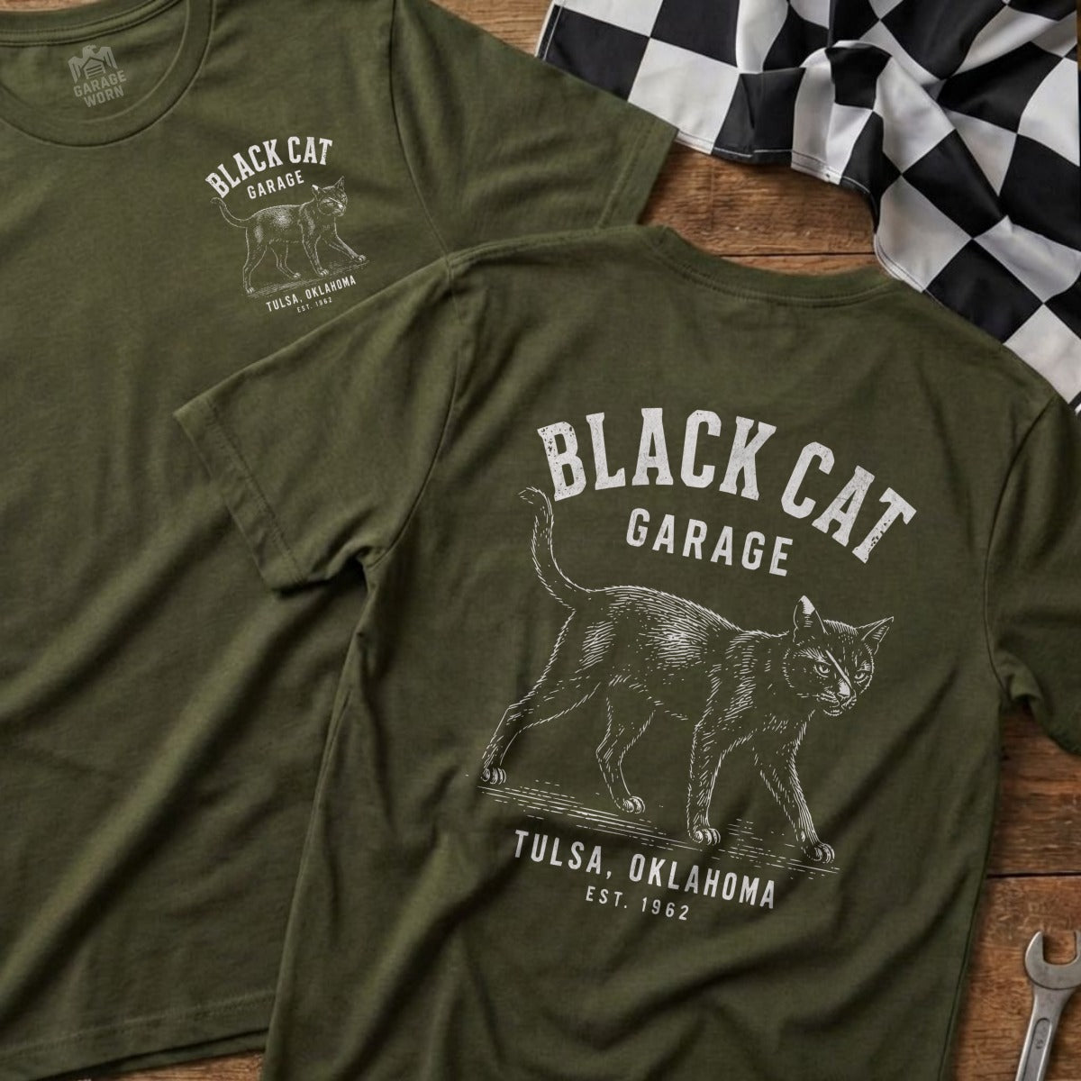 Green t-shirts with "Black Cat Garage", a cat graphic, "Tulsa, Oklahoma", and "Est. 1962".