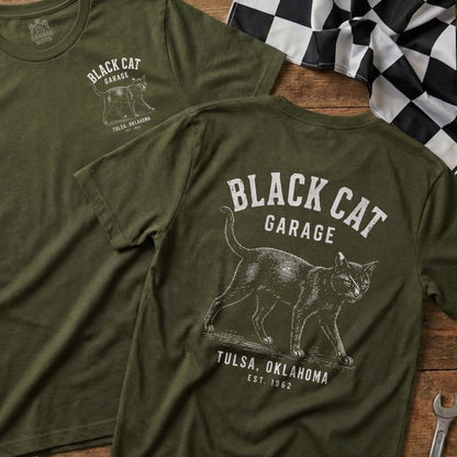 Green t-shirts with "Black Cat Garage", a cat graphic, "Tulsa, Oklahoma", and "Est. 1962".