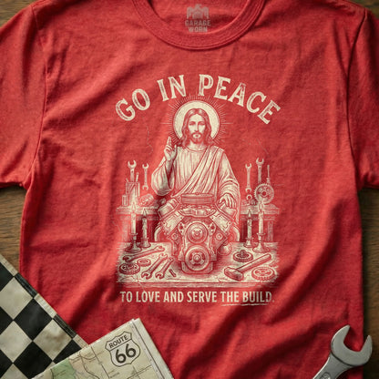 Red t-shirt with Jesus working on an engine, "Go In Peace" and "To Love And Serve The Build."
