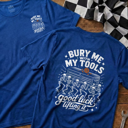 Blue t-shirt with skeletons carrying a toolbox and text "Bury me with my tools, good luck lifting it".