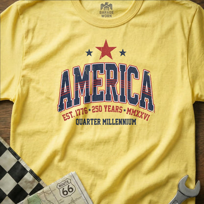Yellow t-shirt with "America Quarter Millennium" in red, white, and blue text.