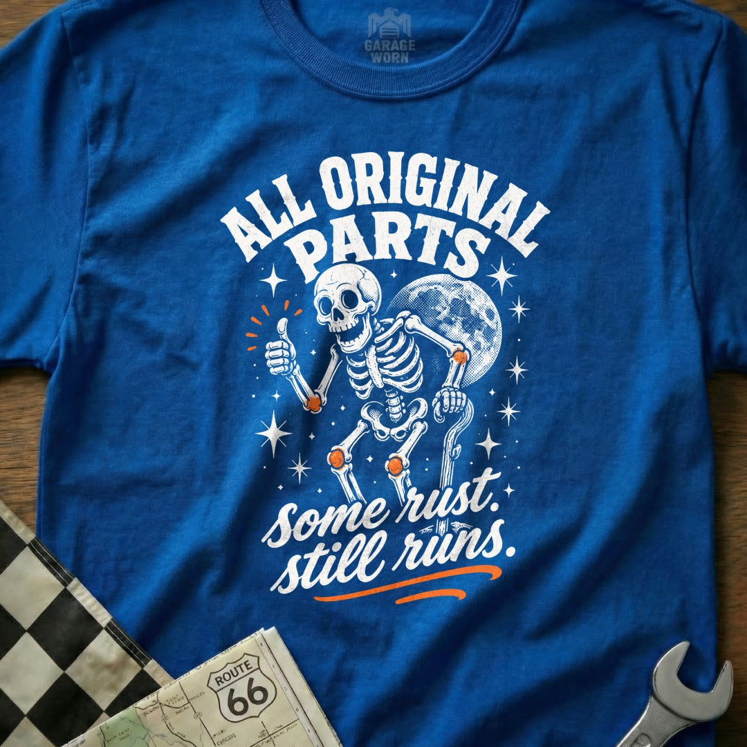 Blue t-shirt with skeleton graphic and text "All Original Parts Some Rust Still Runs."