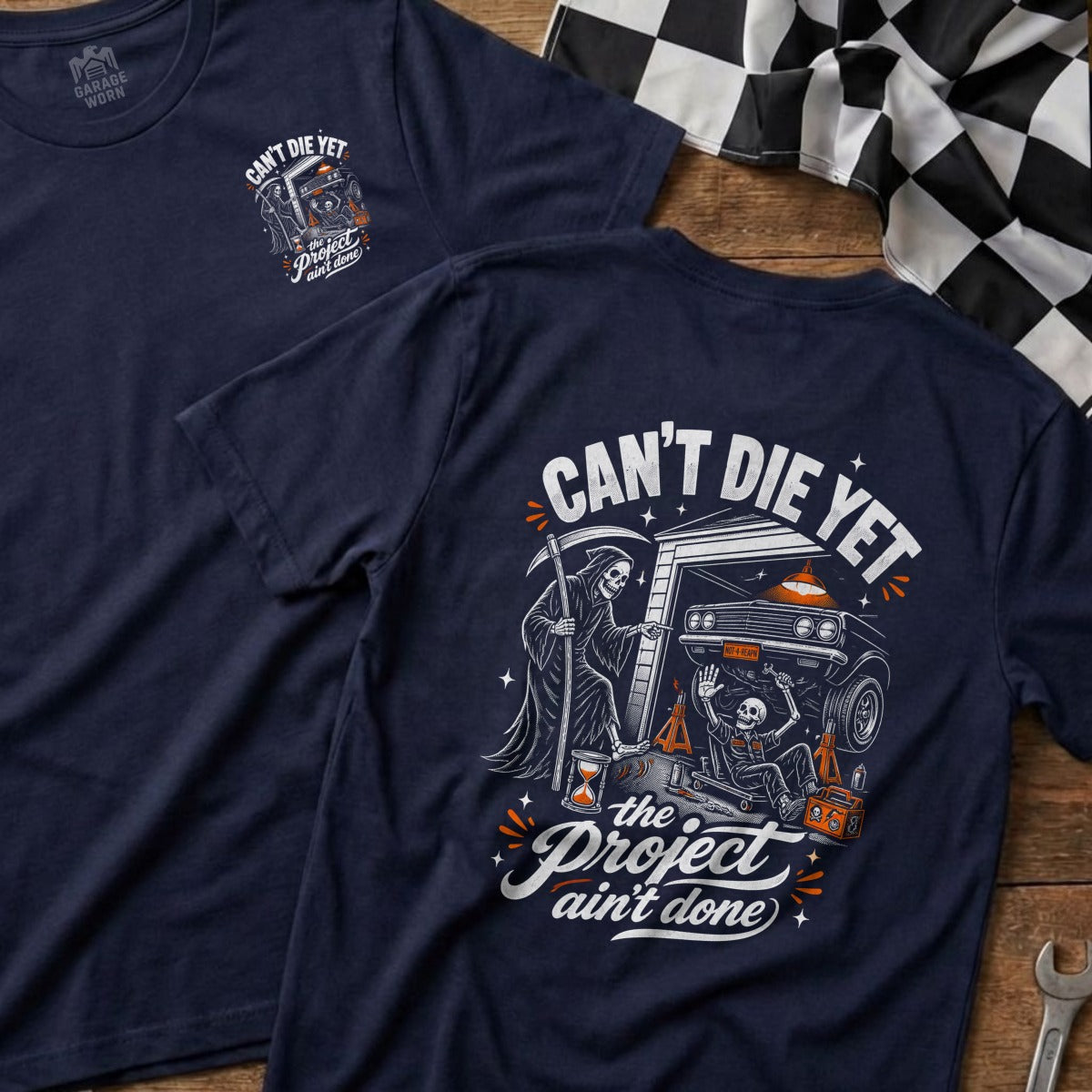 Navy t-shirt with grim reaper and skeleton working on a car, "Can't Die Yet" text.