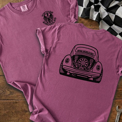 Two maroon t-shirts, one showing a rear view of a VW Beetle with text.