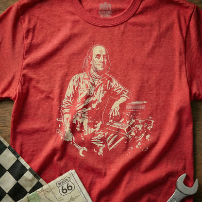Benjamin Franklin leaning on engine with tools and Route 66 map.