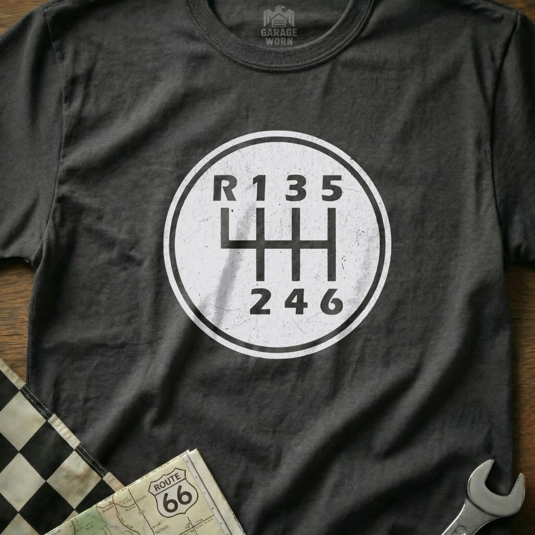 T-shirt with a white circle graphic of a manual transmission shift pattern.
