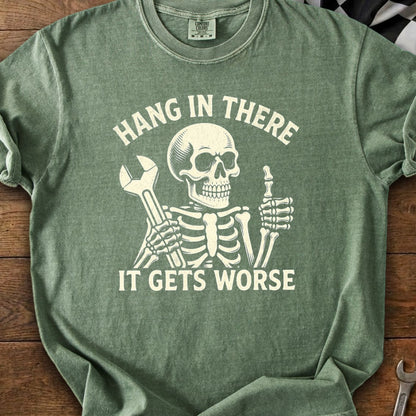Skeleton holding wrench and giving thumbs up, with text "HANG IN THERE IT GETS WORSE".